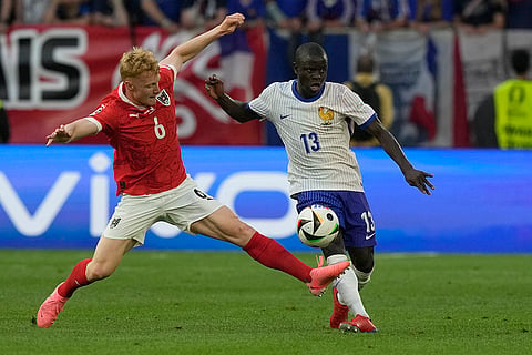Nicolas Seiwald challenges for the ball with N'Golo Kante